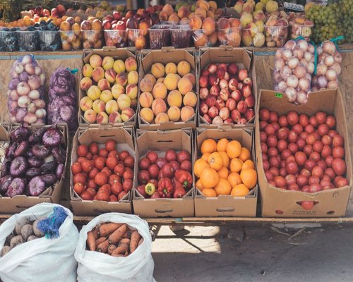 A variety of fresh vegetables and fruits displayed at a traditional Chilean open-air market