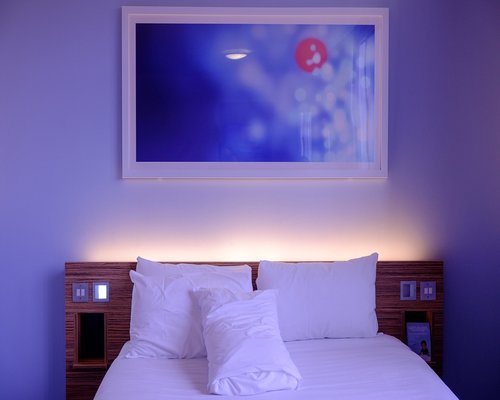 A clean, minimalist bedroom setup with soft lighting, ideal for resting